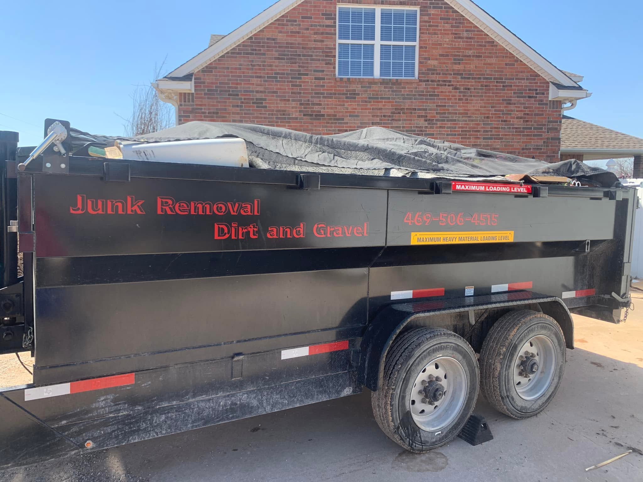 Garcia Dumpster Rental junk removal trailer loaded and covered